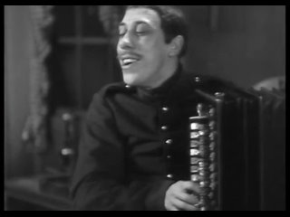 the young fernandel sings while accompanying himself with the chord on